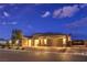 Charming single-story home featuring a three-car garage and desert landscaping at dusk at 8445 S Tenaya Way, Las Vegas, NV 89113