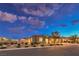 Beautiful single story home with desert landscaping, lush bushes and a gated driveway at 8445 S Tenaya Way, Las Vegas, NV 89113