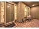 Inviting front entryway with a covered porch, welcome mat, bench seating, and sidelight windows at 8445 S Tenaya Way, Las Vegas, NV 89113