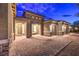 Stunning home exterior featuring a stone facade, three-car garage, and a welcoming brick paved entryway at 8445 S Tenaya Way, Las Vegas, NV 89113