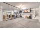 Spacious garage with high ceilings, overhead storage racks, workout equipment, and plenty of room for vehicles at 8445 S Tenaya Way, Las Vegas, NV 89113