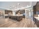 Open-concept kitchen showcases a massive island, stainless appliances and modern finishes at 8445 S Tenaya Way, Las Vegas, NV 89113
