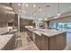 Gourmet kitchen featuring a large central island, modern appliances, custom cabinetry, and pendant lighting at 8445 S Tenaya Way, Las Vegas, NV 89113