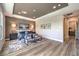Bright and spacious main bedroom with wood-look flooring, designer accents, and an abundance of natural light at 8445 S Tenaya Way, Las Vegas, NV 89113