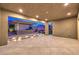 Well-lit covered patio with a built-in outdoor kitchen and manicured landscaping at 8445 S Tenaya Way, Las Vegas, NV 89113