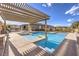 Inviting pool area features a pergola and plenty of space for sunbathing and outdoor relaxation at 8445 S Tenaya Way, Las Vegas, NV 89113