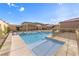 Lush backyard with a pool and spa, framed by a pergola and privacy fencing, perfect for summer enjoyment at 8445 S Tenaya Way, Las Vegas, NV 89113