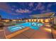 Beautifully lit pool and spa with a pergola, enhanced by lush landscaping and ambient lighting at 8445 S Tenaya Way, Las Vegas, NV 89113