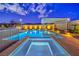 Gorgeous pool and spa with a pergola, surrounded by manicured landscaping and ambient lighting at 8445 S Tenaya Way, Las Vegas, NV 89113