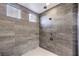 The modern shower includes stylish gray tiling, a built-in seat, and a rainfall shower head at 8445 S Tenaya Way, Las Vegas, NV 89113