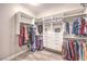 The large walk-in closet is fitted with custom shelving and ample storage for clothes and accessories at 8445 S Tenaya Way, Las Vegas, NV 89113