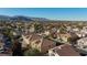 Sprawling community featuring well-maintained homes, palm trees and mountain views under a clear blue sky at 8617 Copper Ridge Ave, Las Vegas, NV 89129