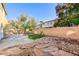Spacious backyard with concrete patio, stone details, and green turf at 8617 Copper Ridge Ave, Las Vegas, NV 89129
