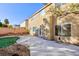 Back exterior of the home featuring a concrete patio, desert landscaping, and a view of neighboring houses at 8617 Copper Ridge Ave, Las Vegas, NV 89129