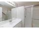 Bright bathroom featuring a white vanity, large mirror, and walk-in shower with glass door at 8617 Copper Ridge Ave, Las Vegas, NV 89129
