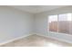 Bright bedroom with a ceiling fan and natural light from the large window, neutral walls and tile flooring at 8617 Copper Ridge Ave, Las Vegas, NV 89129