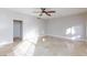 Sun-filled neutral bedroom featuring tile flooring, ceiling fan and a door to the bathroom at 8617 Copper Ridge Ave, Las Vegas, NV 89129