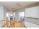 Hallway with hardwood floors, white cabinets, and a view into other rooms at 8617 Copper Ridge Ave, Las Vegas, NV 89129