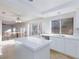 Bright kitchen with white cabinets, quartz countertops, tile flooring, and stainless steel appliances at 8617 Copper Ridge Ave, Las Vegas, NV 89129