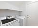 Laundry room featuring a washer, dryer, shelf, and exterior access door at 8617 Copper Ridge Ave, Las Vegas, NV 89129