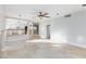 Open concept living room with tile flooring, neutral paint, ceiling fan and an open-concept kitchen at 8617 Copper Ridge Ave, Las Vegas, NV 89129
