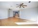 Open living room featuring hardwood floors, ceiling fans, and open access to stairs at 8617 Copper Ridge Ave, Las Vegas, NV 89129