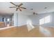 Spacious living room with light hardwood floors, high ceilings, and two ceiling fans at 8617 Copper Ridge Ave, Las Vegas, NV 89129