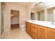 Bright bathroom featuring a double vanity, tiled floor, and glass shower door at 8777 W Maule Ave # 1087, Las Vegas, NV 89148