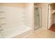 Clean bathroom showcases a tub with a shower, tile flooring, and a bright, inviting atmosphere at 8777 W Maule Ave # 1087, Las Vegas, NV 89148