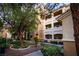 Exterior view of a condominium showcasing well-maintained landscaping and a neutral color palette at 8777 W Maule Ave # 1087, Las Vegas, NV 89148