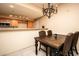 Charming dining room with tiled floors and classic chandelier lighting at 8777 W Maule Ave # 1087, Las Vegas, NV 89148
