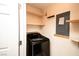 Bright laundry area with modern washer, practical shelving for storage, and easy access to the rest of the home at 8777 W Maule Ave # 1087, Las Vegas, NV 89148