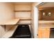 Convenient laundry room featuring built-in shelves, modern washing machine, and adjacent entry to the kitchen at 8777 W Maule Ave # 1087, Las Vegas, NV 89148