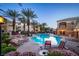 Beautiful community pool area with ample seating, lush landscaping, and inviting lounge chairs for relaxation at 8777 W Maule Ave # 1087, Las Vegas, NV 89148