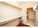 Walk-in closet featuring built-in shelving, wood floors, and access to an attached bathroom at 8777 W Maule Ave # 1087, Las Vegas, NV 89148