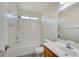 Bright bathroom featuring a single sink vanity, toilet, and shower-tub combo at 8787 Tom Noon Ave # 101, Las Vegas, NV 89178