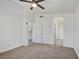 Bright bedroom featuring neutral carpet, ceiling fan, and ensuite bathroom access at 8787 Tom Noon Ave # 101, Las Vegas, NV 89178