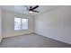 Neutral bedroom featuring carpet, ceiling fan, and a large window at 8787 Tom Noon Ave # 101, Las Vegas, NV 89178