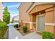Charming townhome with lush landscaping along the walkway leading to a welcoming front entrance and door at 8787 Tom Noon Ave # 101, Las Vegas, NV 89178