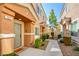 Inviting townhome entrance with manicured landscaping and a walkway leading to a cozy front porch area at 8787 Tom Noon Ave # 101, Las Vegas, NV 89178