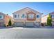 Charming townhome featuring a three-car garage and a balcony, creating an inviting and modern facade at 8787 Tom Noon Ave # 101, Las Vegas, NV 89178
