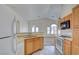 Open kitchen and bright living area features white appliances and neutral accents at 8787 Tom Noon Ave # 101, Las Vegas, NV 89178