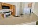 Functional kitchen with stainless appliances, a breakfast bar, and ample cabinetry for a modern living experience at 8787 Tom Noon Ave # 101, Las Vegas, NV 89178
