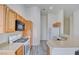 Kitchen featuring light wood cabinets, marble-style countertops, and white appliances at 8787 Tom Noon Ave # 101, Las Vegas, NV 89178