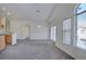 Spacious living room featuring large windows that let in plenty of natural light and neutral carpeting at 8787 Tom Noon Ave # 101, Las Vegas, NV 89178