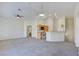 Spacious living room is carpeted and provides an open view to the kitchen and natural light at 8787 Tom Noon Ave # 101, Las Vegas, NV 89178