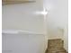 A view up a carpeted stairway shows natural light, and a white bannister on a textured wall at 8787 Tom Noon Ave # 101, Las Vegas, NV 89178