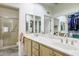 Bright bathroom features dual sinks, large mirrors, and a separate shower and closet at 9000 Sundial Dr, Las Vegas, NV 89134