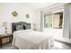 Comfortable bedroom with a decorative headboard and bright window at 9000 Sundial Dr, Las Vegas, NV 89134