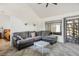 Spacious living room featuring a large sectional sofa, vaulted ceilings, and access to the sunroom at 9000 Sundial Dr, Las Vegas, NV 89134